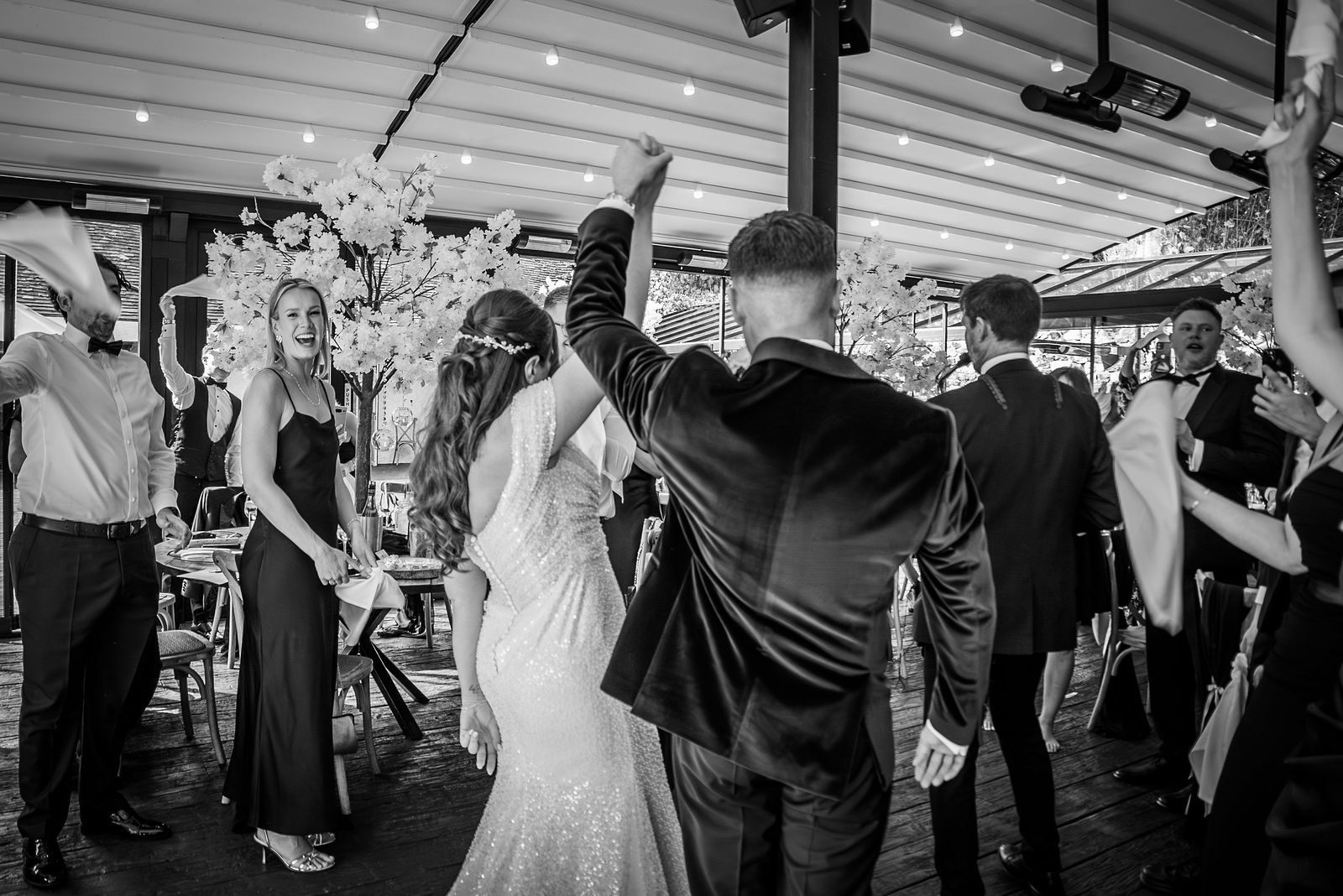 A bride and groom celebrate their wedding at the Buttery and Glasshouse wedding venue in Kent