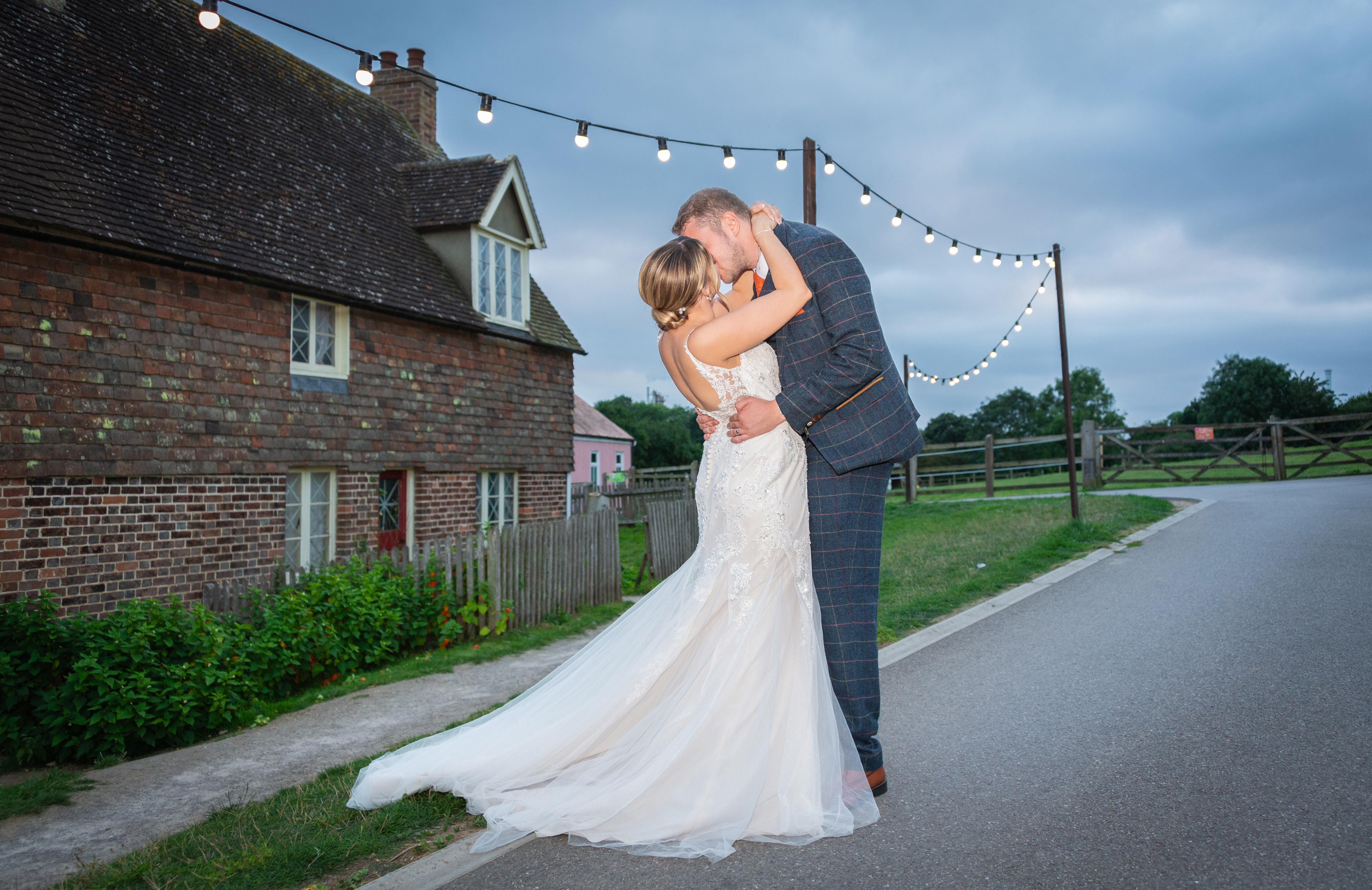 Relaxed couples photography under the festoon lights at Kent Life wedding venue